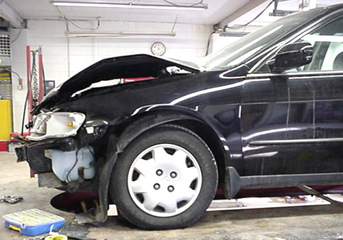 Before photo of a black car with front-end collision damage
